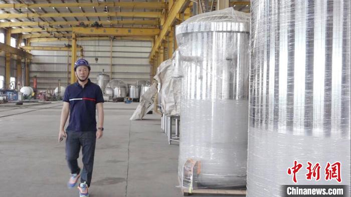 汪光典在不銹鋼罐體生產(chǎn)車間?！垈髅?攝