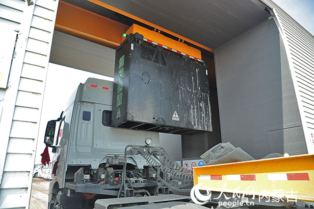 萬(wàn)利新能源數(shù)字陸港里，正在充換電站進(jìn)行換電的重卡。人民網(wǎng)記者 趙夢(mèng)月攝