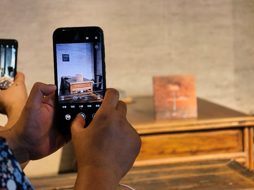 2025年7月15日，暑期研學(xué)團(tuán)小朋友在浙江省紹興市三味書屋拍攝魯迅讀書座位及課桌上的“早”字。受訪者供圖